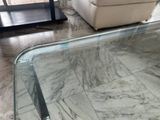a glass coffee table with a glass top in a living room