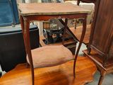a small table with a chair on top of it in a room