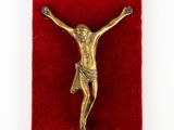 an image of a gold crucif on a red velvet box