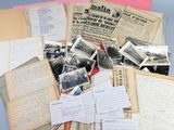 a pile of old papers and old photos on a table