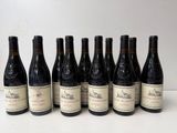 six bottles of wine are lined up in a row on a table
