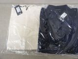 a black shirt and a white t - shirt in a plastic bag