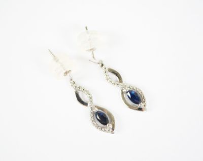 pair of sapphire and diamond earrings on a white background