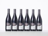six bottles of wine lined up in a row on a table