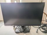 a computer monitor sitting on top of a table