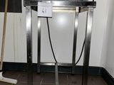 a metal table with a mop on top of it in a room