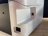 underside view of a silver laptop computer sitting on top of a wooden table