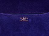 a close up of a blue purse with a gold logo on it