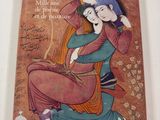 un vieux livre sur lequel figure l'image d'une femme assise par terre