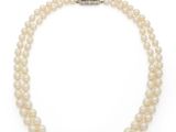 a single strand of white pearls with a silver clasp