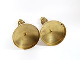 pair of antique brass door knobs on a white background