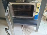 a small oven with a pot on top of it