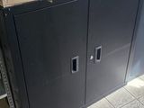 boxes are stacked on top of a metal cabinet in a kitchen