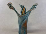 a glass vase with two toothbrushes sticking out of it
