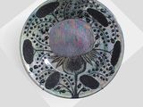a black and white plate with a flower design on it