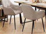 two chairs that are sitting at a table in a room