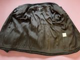 a close up of a black jacket on a pink surface