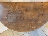 a wooden table with a wooden top on a tiled floor
