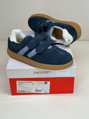 a pair of blue and white shoes sitting on top of a box
