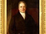 portrait of a man in a black coat and white shirt