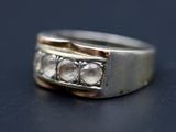 une image d'une bague en diamant sur une surface noire