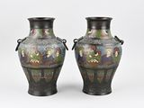 pair of decorative vases sitting on top of a white surface