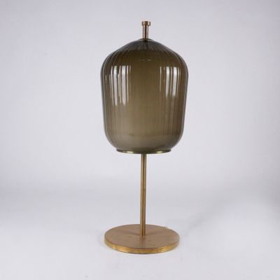 a brown glass table lamp on a gold metal base