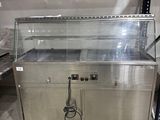 a metal counter with a glass top in a warehouse