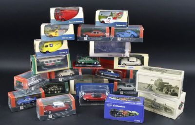 many different models of cars in boxes on a black surface