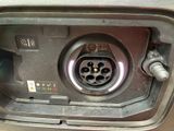 a close up of a car ' s fuel tank with a car plugged in
