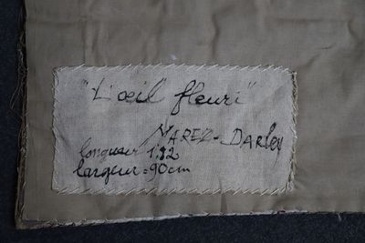 a piece of fabric with writing on it on the floor