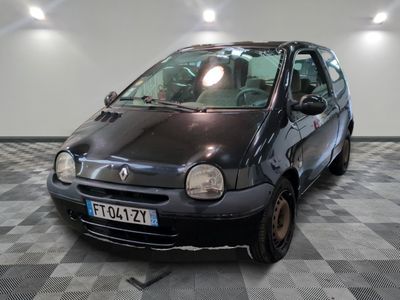 a small black car parked in a room with a checkered floor