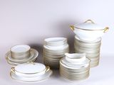 a lot of white and gold plates and cups