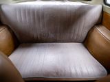 a seat in the back of a bus with a window open