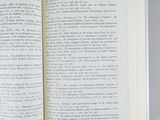 an open book on a table with a pen in it
