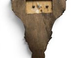 a piece of wood with holes in the middle of it