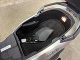 a seat in the trunk of a scooter