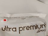 a bag of dog food sitting on a bed