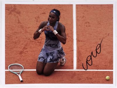 signed photograph of a woman sitting on a tennis court holding a tennis racquet