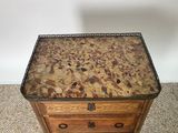 a small wooden table with a marble top on the floor