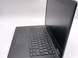a black laptop computer sitting on a white surface