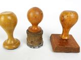 three different types of wooden stampers on a white surface