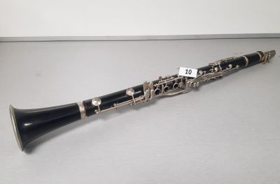 a close up of a clarinet on a table with a price tag on it