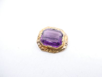 a close up of a purple stone on a white surface