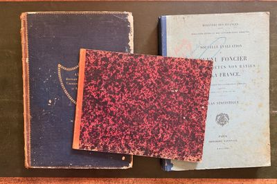 two old books sitting on top of a table next to each other