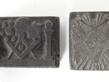 two small metal stamps with a picture of a man and a woman on them