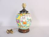 a lamp that is sitting on a table next to a flower vase