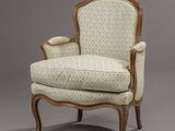 an upholstered chair with a wooden frame and upholstered upholstered seat