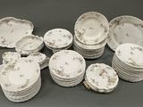 a lot of plates and bowls sitting on a table