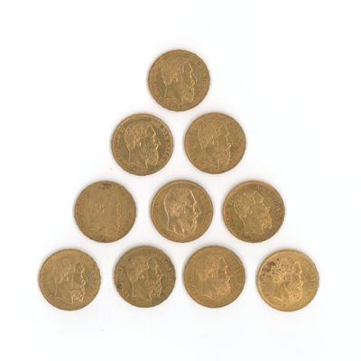 un tas de pièces d'or disposées en pyramide sur une surface blanche